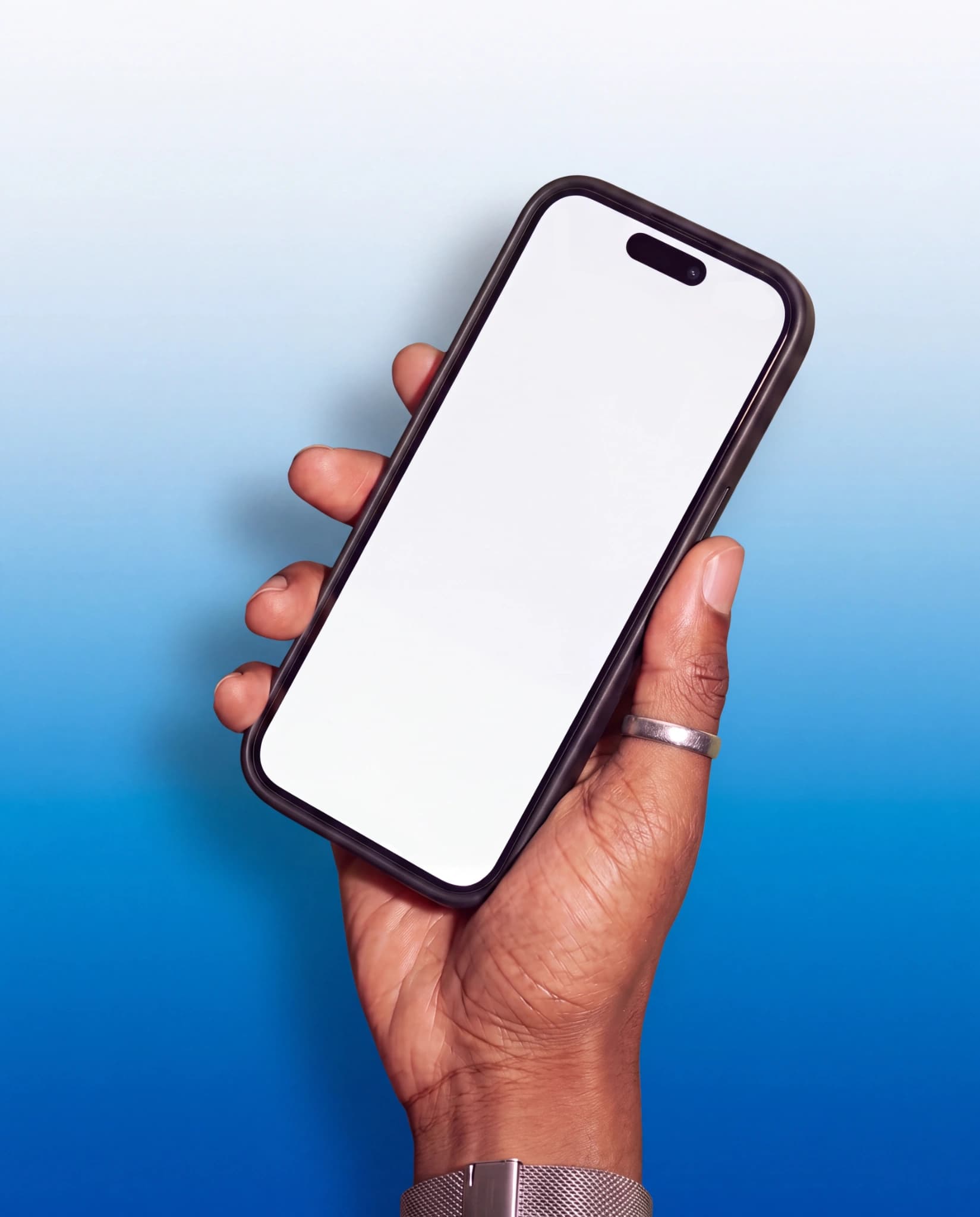 Modern purple iPhone held diagonally in one hand wearing a silver mesh watch and ring against a vivid blue gradient studio background, with an editable white display and visible Dynamic Island