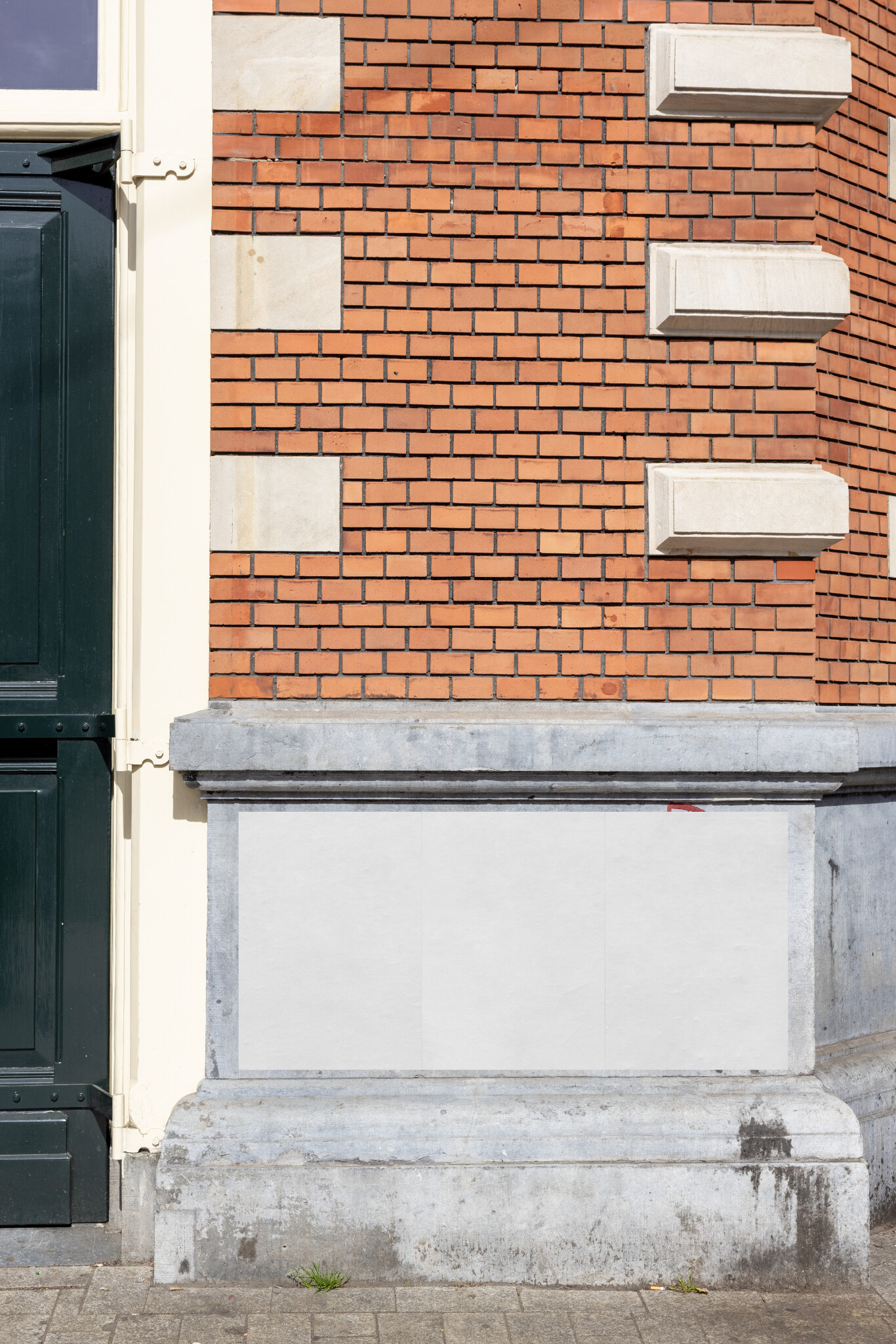Amsterdam urban street poster mockup on a classic brick façade with three posters in white, perfect for realistic design presentations in Stadsschouwburg Amsterdam