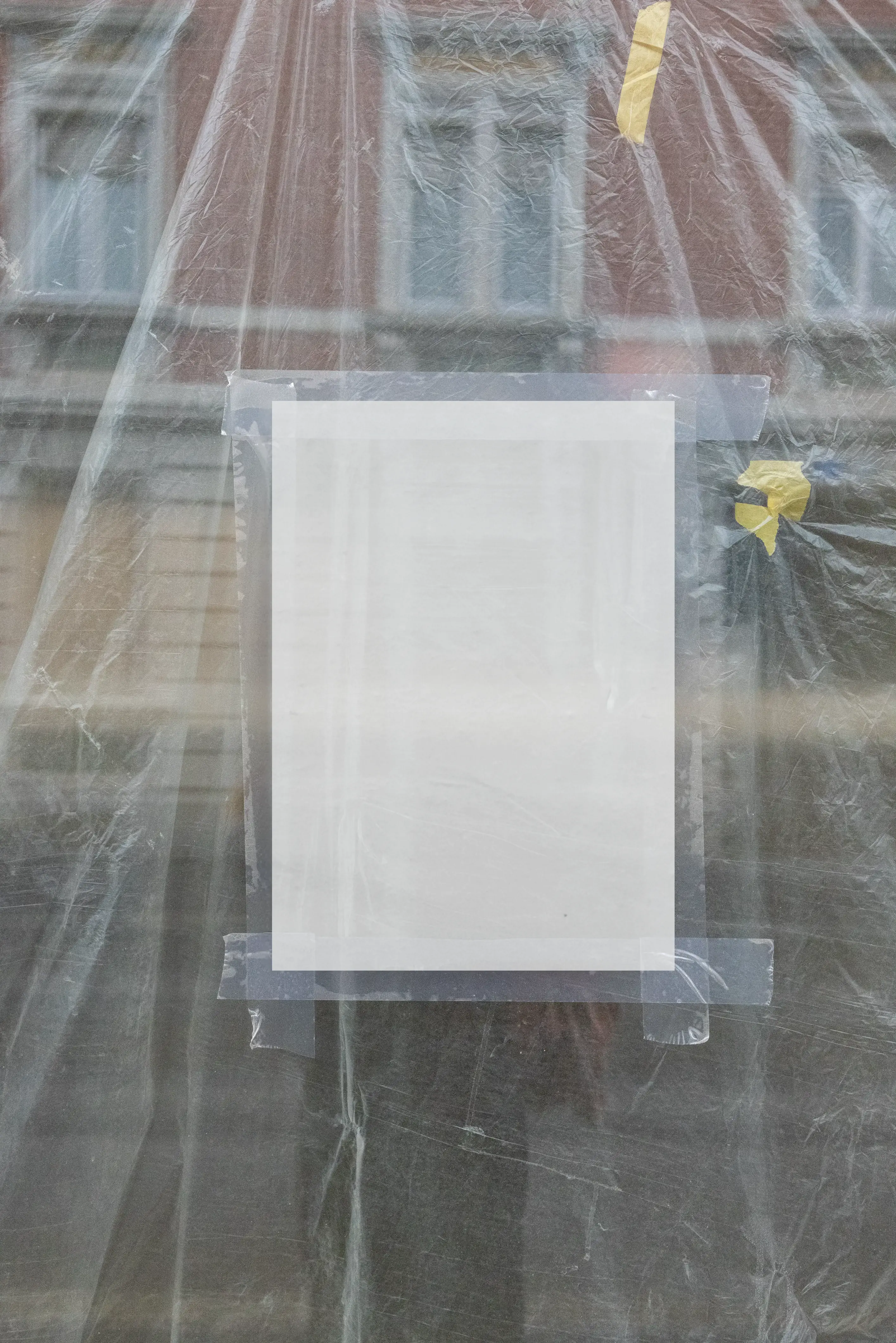 Basel taped window poster behind construction film – JM303 Blank DIN A4 poster taped behind translucent construction film in a street-level window in Basel